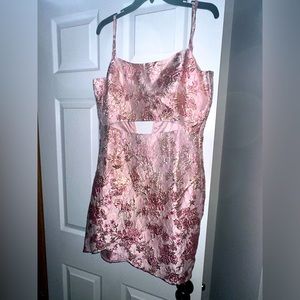 NWOT. Short dress with stomach slit. Small straps with zip up back.